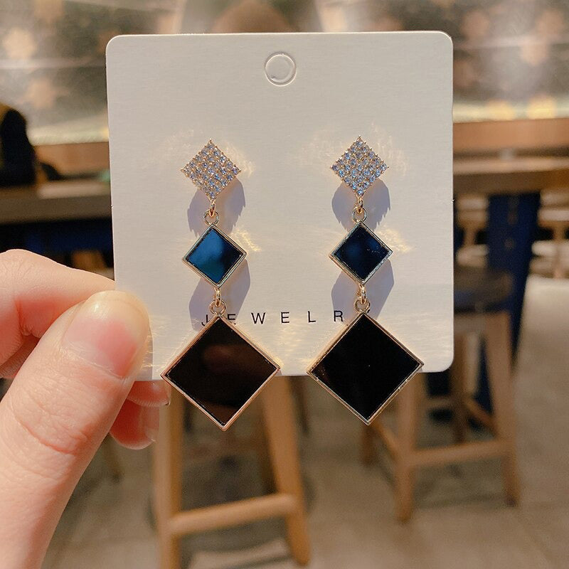 Asymmetrische hohle Liebesherz-Ohrringe mit langer Quaste