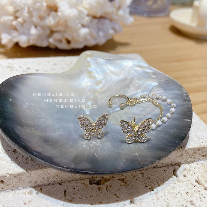 Asymmetrische Schmetterlings-Glamour-Ohrringe mit Strasssteinen und Kette