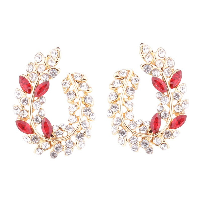 Schillernde, mit Strasssteinen besetzte Ohrstecker aus Acryl in Blattform