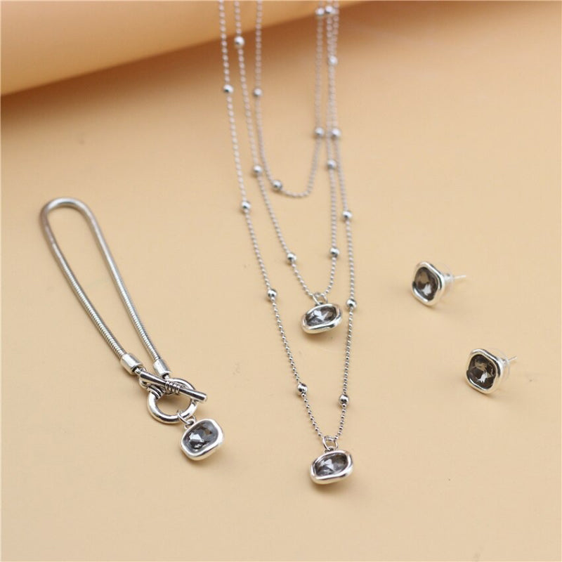 Schmuckset mit Halskette, Ohrringen und Armband in Retro-Quadratform mit Strasssteinen