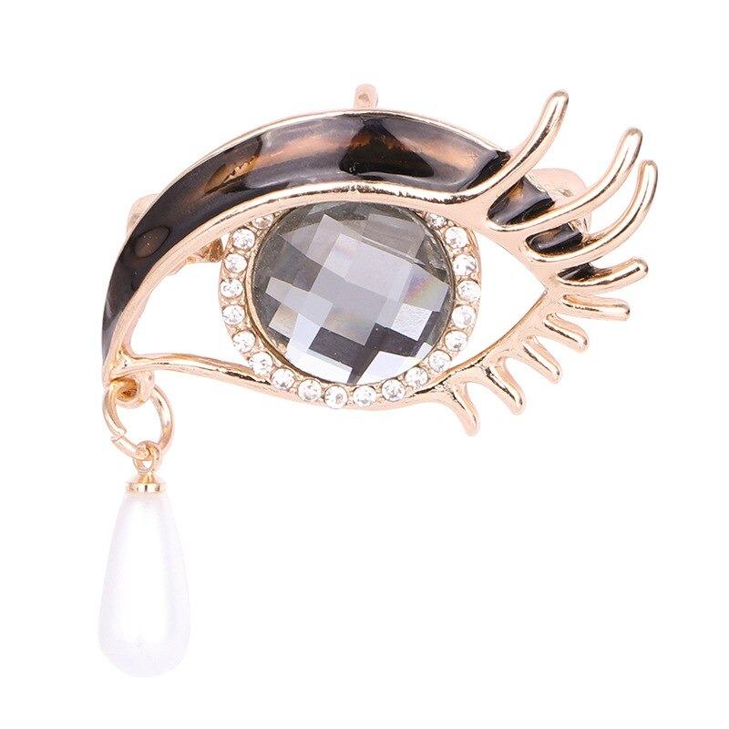 Mit Strasssteinen besetzte Broschennadeln in Augenform