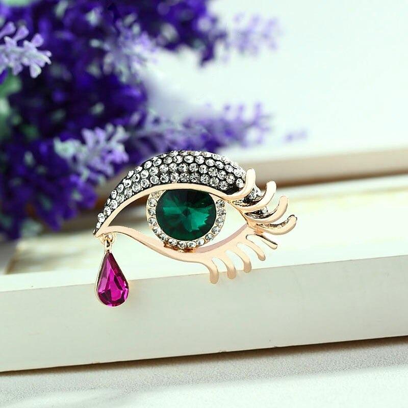 Mit Strasssteinen besetzte Broschennadeln in Augenform