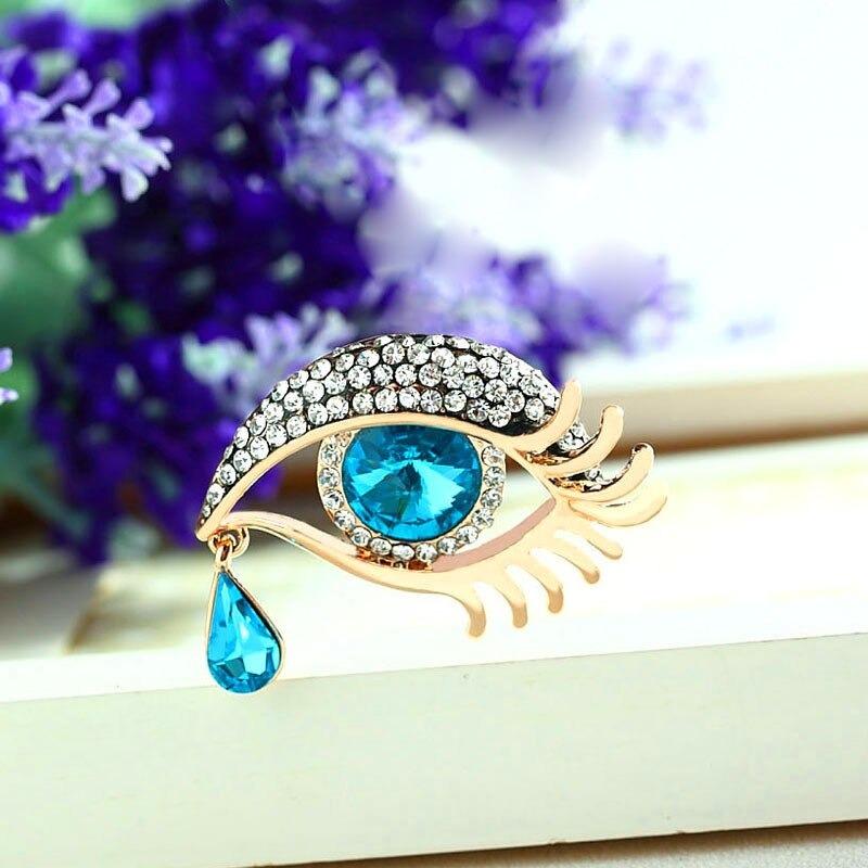 Mit Strasssteinen besetzte Broschennadeln in Augenform