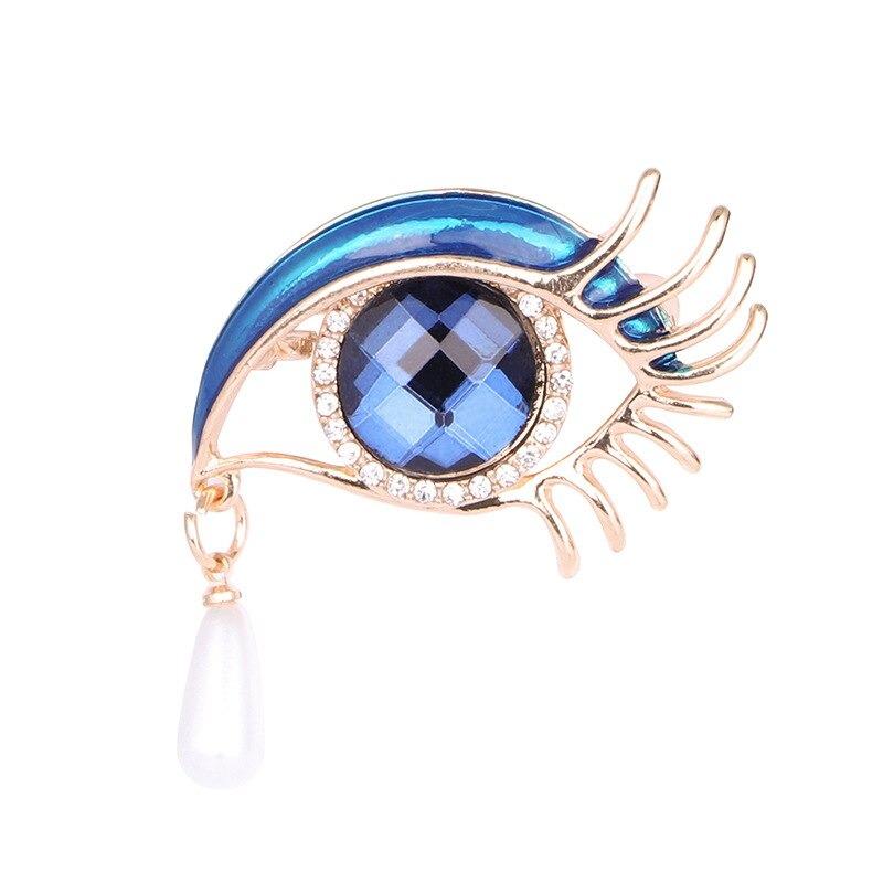 Mit Strasssteinen besetzte Broschennadeln in Augenform