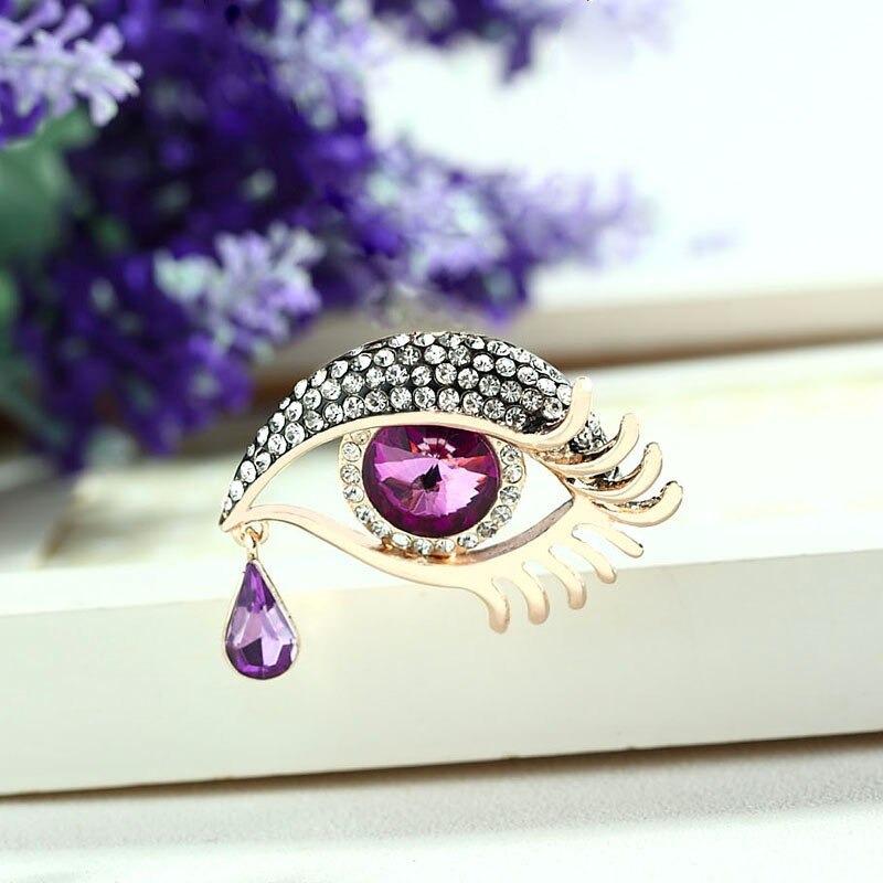 Mit Strasssteinen besetzte Broschennadeln in Augenform