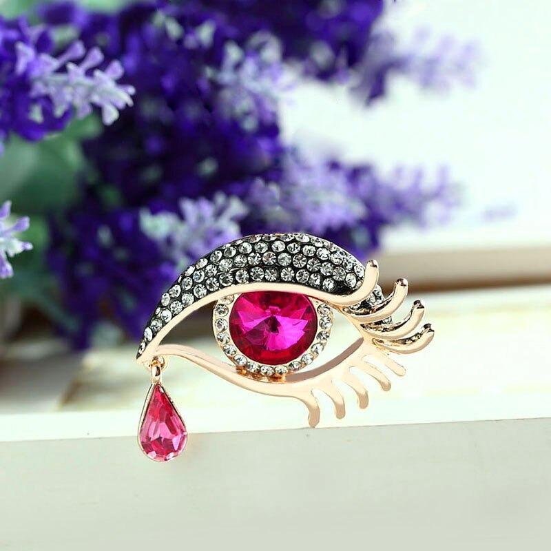 Mit Strasssteinen besetzte Broschennadeln in Augenform