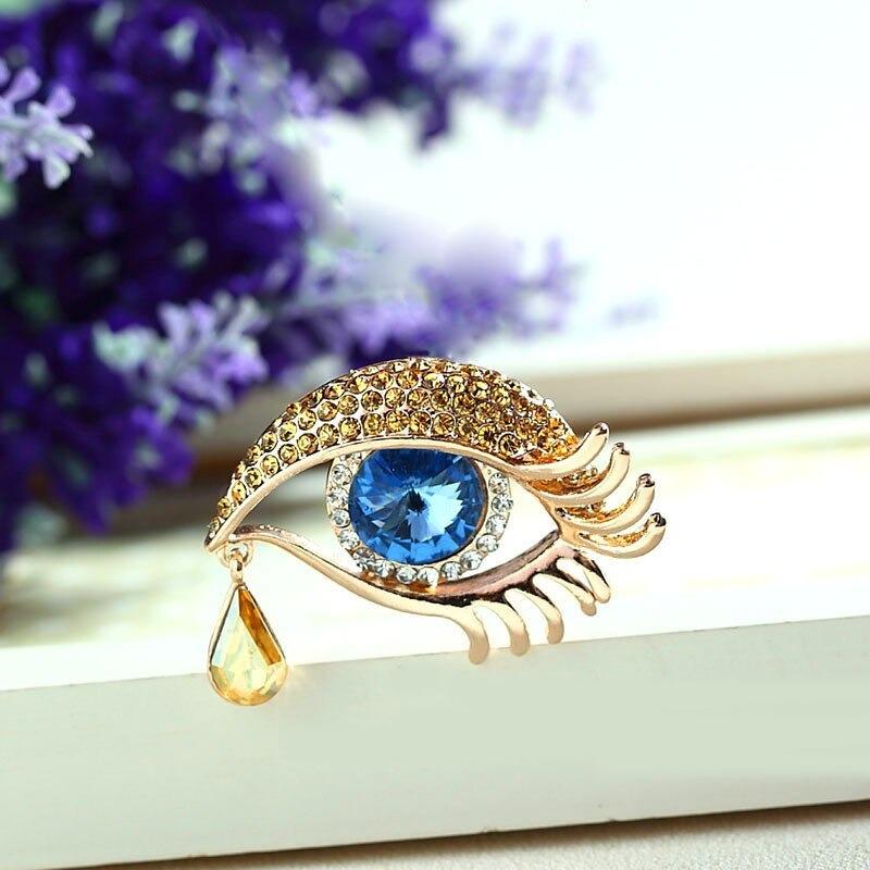 Mit Strasssteinen besetzte Broschennadeln in Augenform