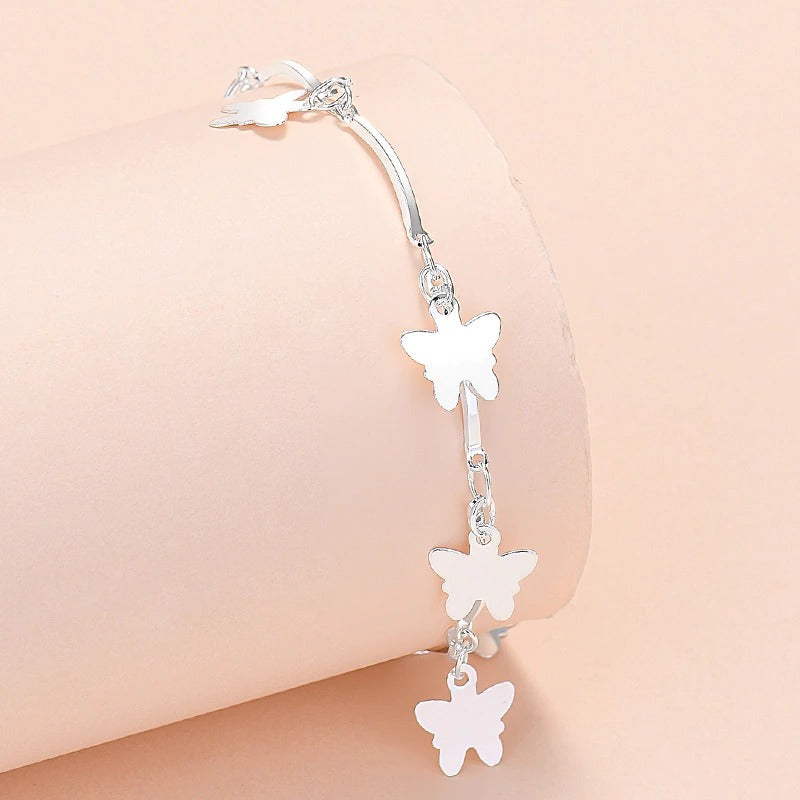 Armbandkollektion mit Schmetterlings- und Kreuz-Charms aus Sterlingsilber