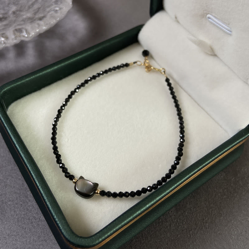 Carmiora 14K vergoldetes schwarzes Spinell-weißes Kristall-Heilarmband mit süßer Katze aus Tridacna-Stein