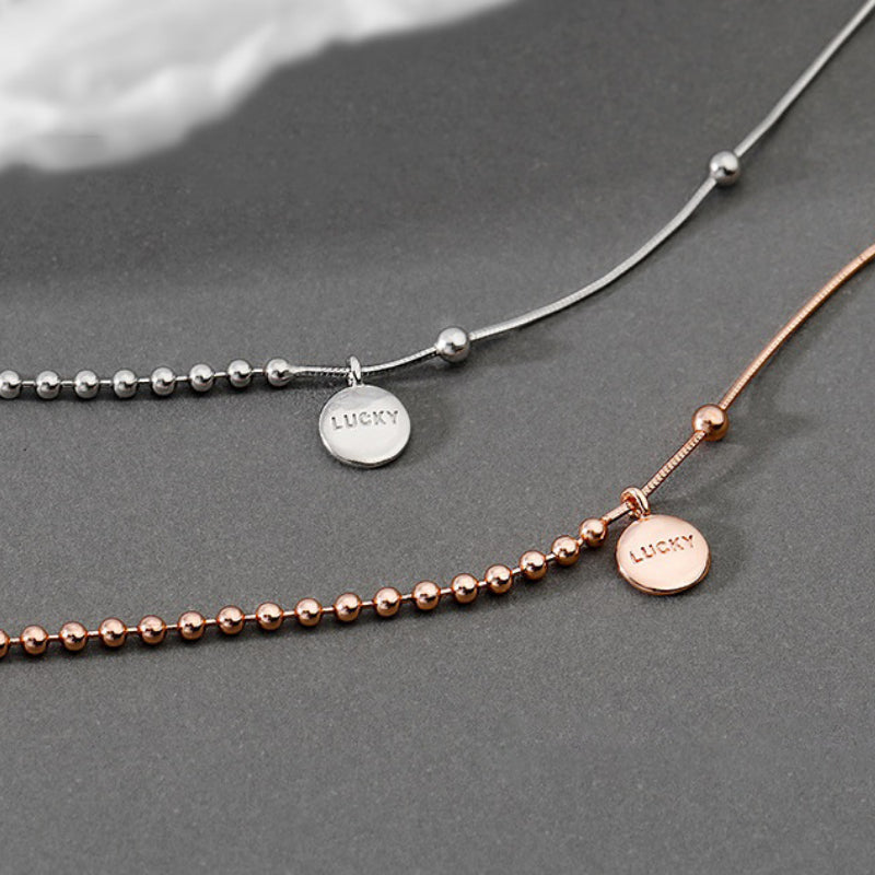 Asymmetrische Perlenkette mit Chokerhalsketten mit Glücksbringer-Anhänger