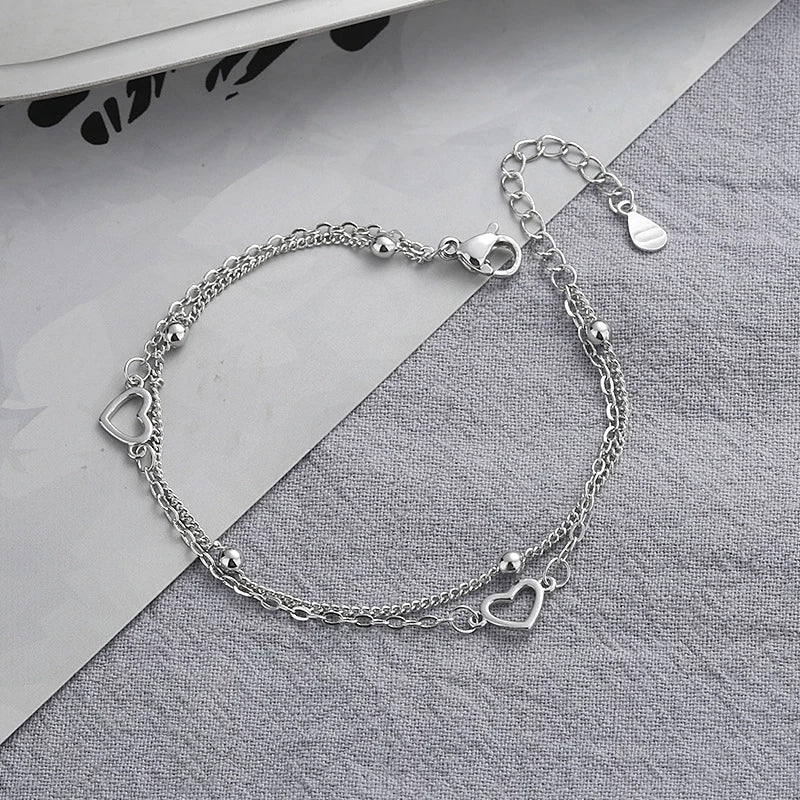 Armband aus Sterlingsilber mit doppeltem Liebesherz und hohlen runden Perlen